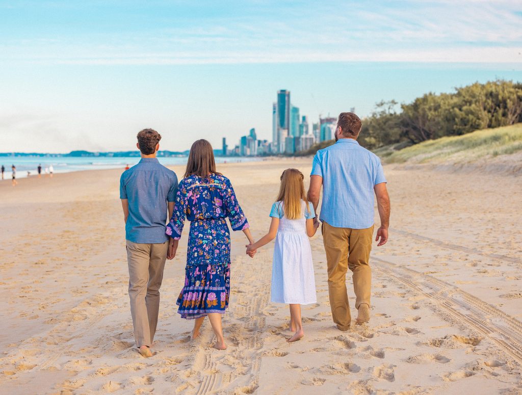 A family walking together on the beach, representing healing, reconnection, and the restoration of family bonds.